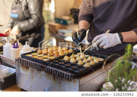 Process of cooking takoyaki balls. 126233942