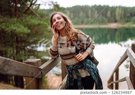 Attractive young woman enjoying fresh air on the lake. Travel, Hiking, nature 126234987