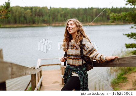 Attractive young woman enjoying fresh air on the lake. Travel, Hiking, nature 126235001