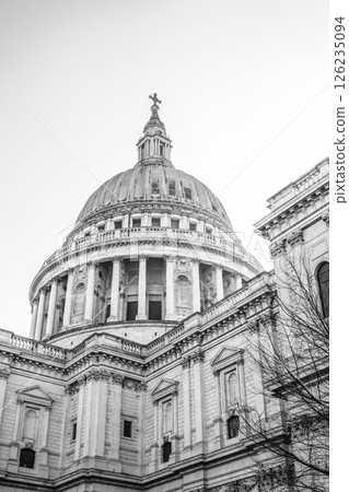 The intricate dome of St. Paul's Cathedral is prominently featured against a clear sky. Its architectural details showcase the historic beauty of London, inviting admiration from visitors. 126235094