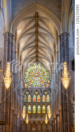 Westminster Abbey showcases stunning gothic architecture with intricate arches and colorful stained glass windows. The interior beautifully highlights the craftsmanship of the era. 126235095