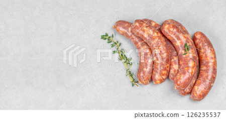 Raw meat sausages. Grilling food, bbq, barbecue. Long banner format. top view Raw meat sausages. Grilling food, bbq, barbecue. Long banner format. top view 126235537