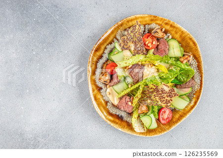 beef steak medium rare, fresh greens and vegetable salad on a light background, top view. copy space 126235569