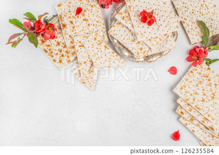 traditional Matzo bread, flowers on light background, symbolizing Passover celebrations. Top view traditional Matzo bread, flowers on light background, symbolizing Passover celebrations. Top view 126235584