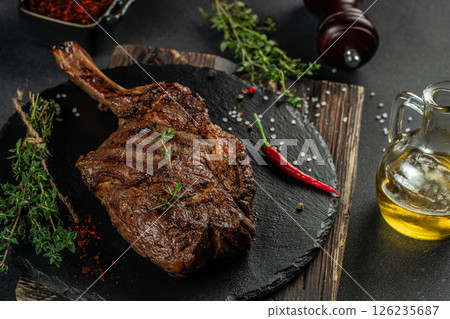 Barbecue Tomahawk Steak on a dark background. top view. copy space for text 126235687