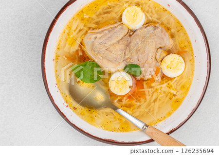 Quail broth or soup in a bowl on a white background top view. copy space 126235694