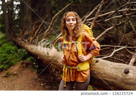 Young woman with backpack traveling outdoors. Hiking, active lifestyle. Young woman with backpack traveling outdoors. Hiking, active lifestyle. 126235724