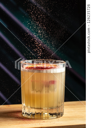 Whiskey sour trendy alcoholic cocktail with bourbon, lemon juice, egg white and ice 126235726
