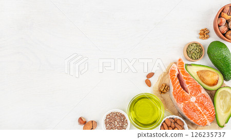 Healthy fat salmon, avocado, oil, nuts, keto diet on white wooden background, copy space, top view Healthy fat salmon, avocado, oil, nuts, keto diet on white wooden background, copy space, top view 126235737