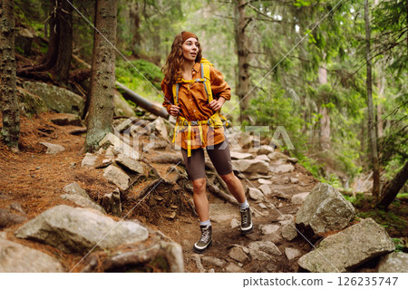 Young woman with backpack traveling outdoors. Hiking, active lifestyle. 126235747