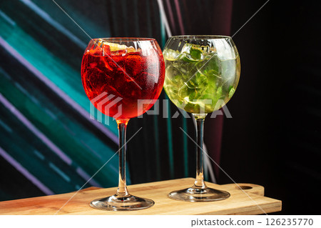 Cocktails assortment served on dark background. aperol spritz and mojito. menu concept Cocktails assortment served on dark background. aperol spritz and mojito. menu concept 126235770