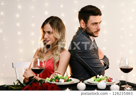 Young Couple Sitting Back To Back On Date In Restaurant, Ignoring Each Other After Arguing 126235863