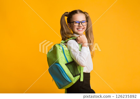 Schoolgirl Posing With School Backpack Smiling To Camera Standing Over Yellow Background. Studio Shot 126235892
