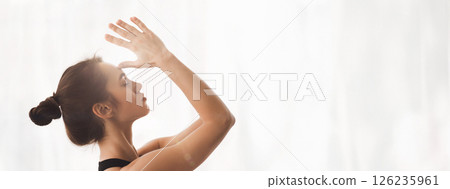A woman engages in yoga and meditation, promoting mindfulness and relaxation in a calm indoor environment, copy space A woman engages in yoga and meditation, promoting mindfulness and relaxation in a calm indoor environment, copy space 126235961