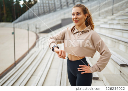 Beautiful woman outdoors and sportswear doing fitness. Concept of sport, recreation. Beautiful woman outdoors and sportswear doing fitness. Concept of sport, recreation. 126236022
