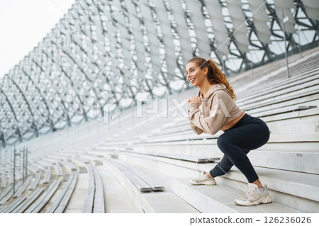 Beautiful woman outdoors and sportswear doing fitness. Concept of sport, recreation. Beautiful woman outdoors and sportswear doing fitness. Concept of sport, recreation. 126236026