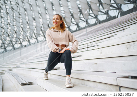 Beautiful woman outdoors and sportswear doing fitness. Concept of sport, recreation. Beautiful woman outdoors and sportswear doing fitness. Concept of sport, recreation. 126236027