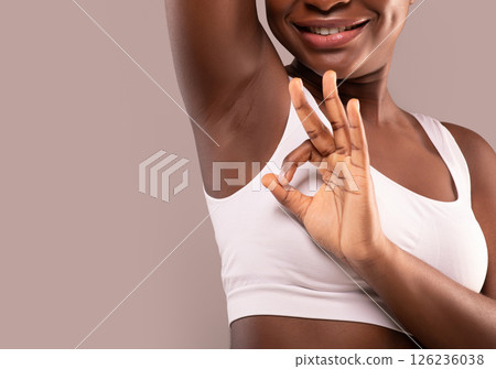 Unrecognizable Smiling Black Lady Demonstrating Her Smooth Clean Armpit And Showing Ok Gesture, Recommending Safe Effective Hair Removal In Underarm Zone, Isolated On Gray Background, Copy Space Unrecognizable Smiling Black Lady Demonstrating Her Smooth Clean Armpit And Showing Ok Gesture, Recommending Safe Effective Hair Removal In Underarm Zone, Isolated On Gray Background, Copy Space 126236038
