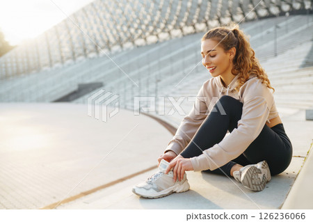 Beautiful woman outdoors and sportswear doing fitness. Concept of sport, recreation. Beautiful woman outdoors and sportswear doing fitness. Concept of sport, recreation. 126236066