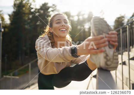 Beautiful woman outdoors and sportswear doing fitness. Concept of sport, recreation. Beautiful woman outdoors and sportswear doing fitness. Concept of sport, recreation. 126236070