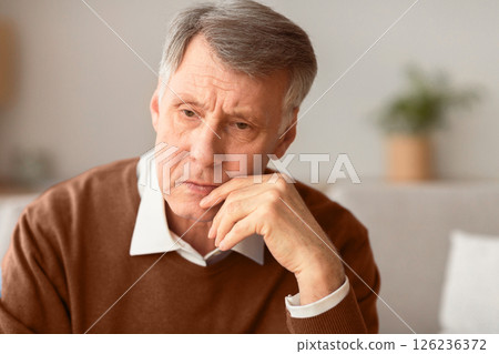 Portrait Of Depressed Senior Gentleman Thinking About Lonely Retired Life Sitting On Couch At Home. Selective Focus 126236372