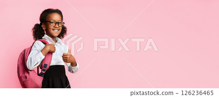 African American School Girl Gesturing Thumbs Up Posing With Backpack And Smiling Over Yellow Studio Background. I Like School 126236465