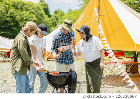 Men and women enjoying a barbecue at camp 126236667