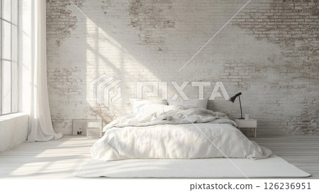 A bright and inviting bedroom features soft white bedding, a simple bedside table, and a stylish lamp. Natural light streams through large windows, enhancing the rustic charm of the brick walls. 126236951