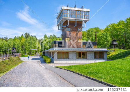 Vojna Memorial located in Lesetice, Czechia, the watch tower stands tall within a former prison complex. Surrounded by greenery, it provides a glimpse into the area's history and architecture. 126237381
