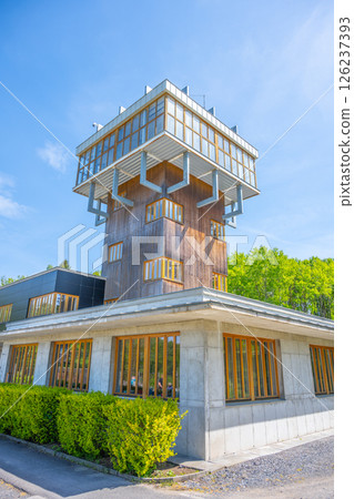 The watch tower stands prominently in the former Vojna prison complex in Lesetice, Czechia. It features a modern design and surrounded by greenery, highlighting its historical significance. The watch tower stands prominently in the former Vojna prison complex in Lesetice, Czechia. It features a modern design and surrounded by greenery, highlighting its historical significance. 126237393