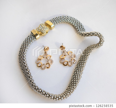 Romantic jewelry set of sterling silver choker necklace and round chain earrings on white background 126238535