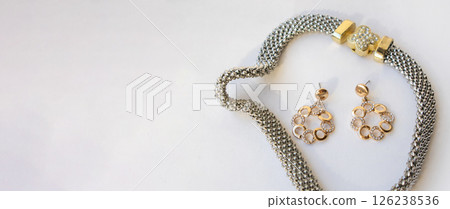 Banner with romantic jewelry set of sterling silver choker necklace and round chain earrings on white background, copy space 126238536