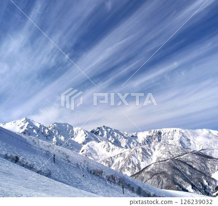 A beautiful and fantastic sky spreads out over the harsh winter in Shinshu, the silver-white Northern Alps, Hakuba Sanzan and the ski slopes. A beautiful and fantastic sky spreads out over the harsh winter in Shinshu, the silver-white Northern Alps, Hakuba Sanzan and the ski slopes. 126239032