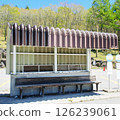 A bus shelter with a sturdy roof 126239061