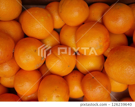 A bunch of oranges are piled up in a box A bunch of oranges are piled up in a box 126239640