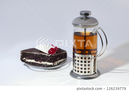 Teapot with metal strainer inside. Kitchen utensils on gray background. Teapot with metal strainer inside. Kitchen utensils on gray background. 126239779