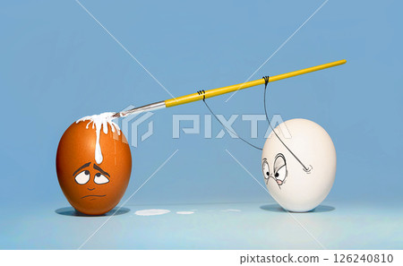 Two chicken eggs, white and brown, are preparing for Easter, and paint each other with a brush with a contented and enthusiastic look Two chicken eggs, white and brown, are preparing for Easter, and paint each other with a brush with a contented and enthusiastic look 126240810