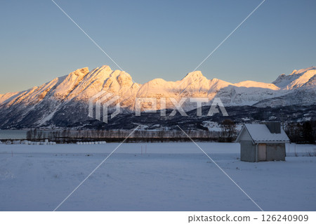 Mountains with snow in sunrise, Hamnvik, Norway Mountains with snow in sunrise, Hamnvik, Norway 126240909