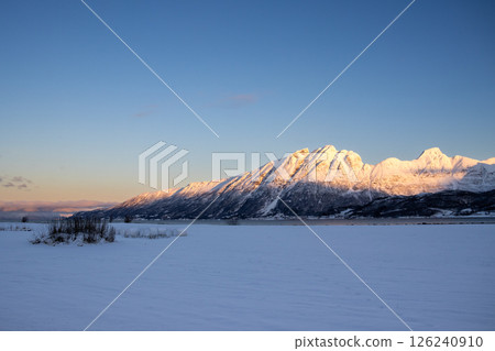 Mountains with snow in sunrise, Hamnvik, Norway Mountains with snow in sunrise, Hamnvik, Norway 126240910