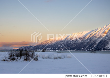Mountains with snow in sunrise, Hamnvik, Norway Mountains with snow in sunrise, Hamnvik, Norway 126240911