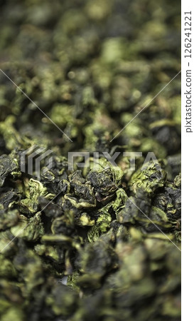A Detailed CloseUp Image of Oolong Tea Leaves Showcasing Unique Textures and Colors. Media 126241221