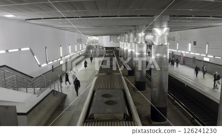 Subway train arriving at platform with passengers waiting. Action 126241230