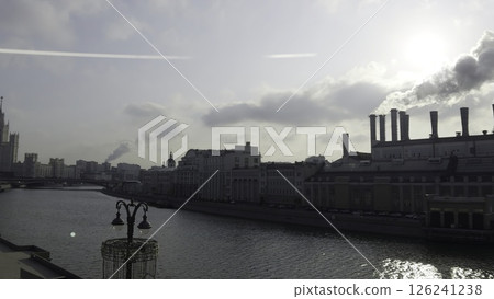 Moscow power plant emitting smoke on moskva river under cloudy sky. Action 126241238