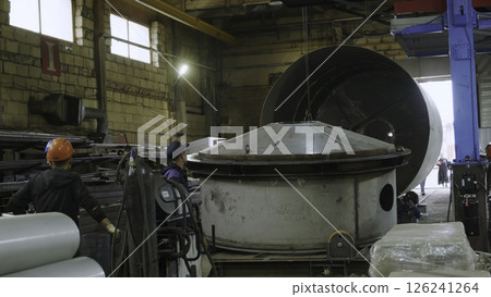 An Industrial Workshop featuring Machinery and Workers Actively Engaged in Their Tasks. Media 126241264