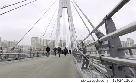 People walking on modern cable stayed bridge in urban area. Action People walking on modern cable stayed bridge in urban area. Action 126241269