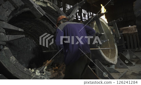 A worker is currently present inside an industrial facility where they are handling equipment. Stock Clip A worker is currently present inside an industrial facility where they are handling equipment. Stock Clip 126241284