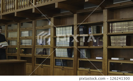 An Elegant Collection of Beautiful Wooden Library Shelves, Filled to the Brim with Numerous Books. Media An Elegant Collection of Beautiful Wooden Library Shelves, Filled to the Brim with Numerous Books. Media 126241300
