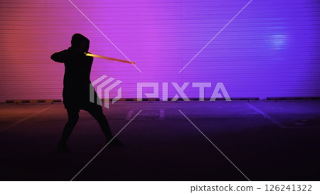 A Dynamic Silhouette illuminated by Neon Lights, wielding a Sword in an engaging scene. Media A Dynamic Silhouette illuminated by Neon Lights, wielding a Sword in an engaging scene. Media 126241322