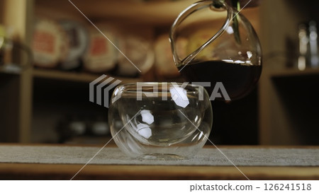 A person pours coffee, tea, and wine, showcasing beverage art. Media A person pours coffee, tea, and wine, showcasing beverage art. Media 126241518