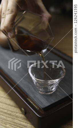 Pouring a fine tea into exquisite traditional Japanese glassware is an art form. Media 126241595